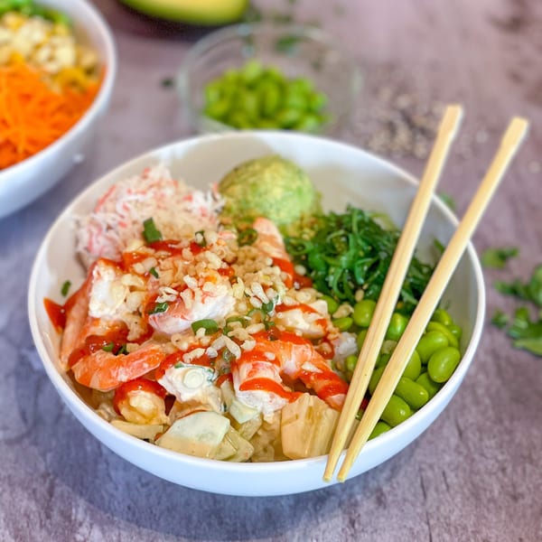 Yo Poké Fusion bowl with shrimp, crab, avocado, seaweed, edamame, and crispy toppings.